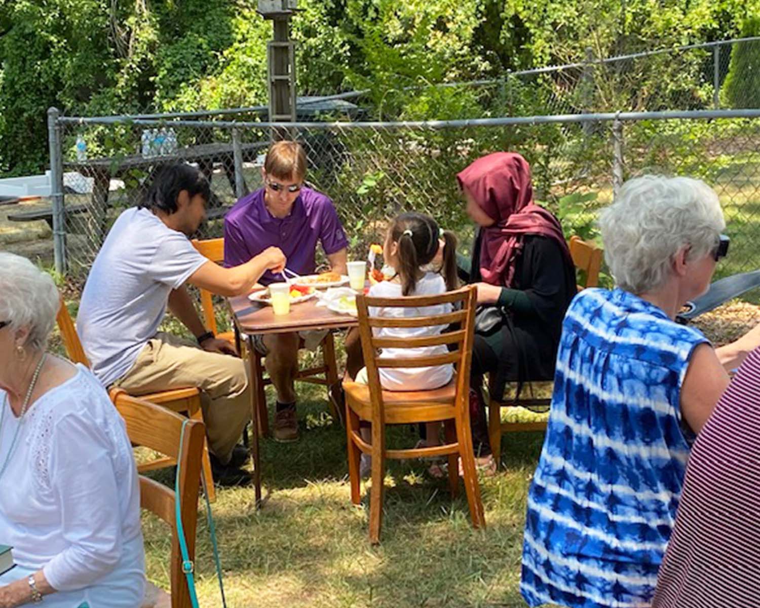 Sponsored family dines in the garden.