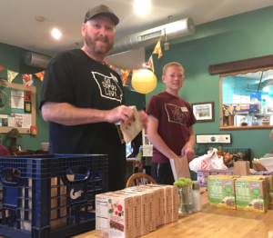 Men packing snacks to go at Tricklebee Cafe